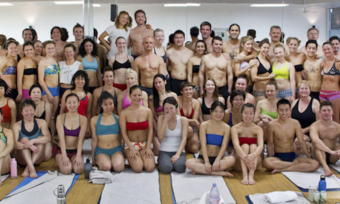Many students in yoga clothes at yoga studio