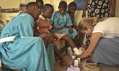 Woman helping African children